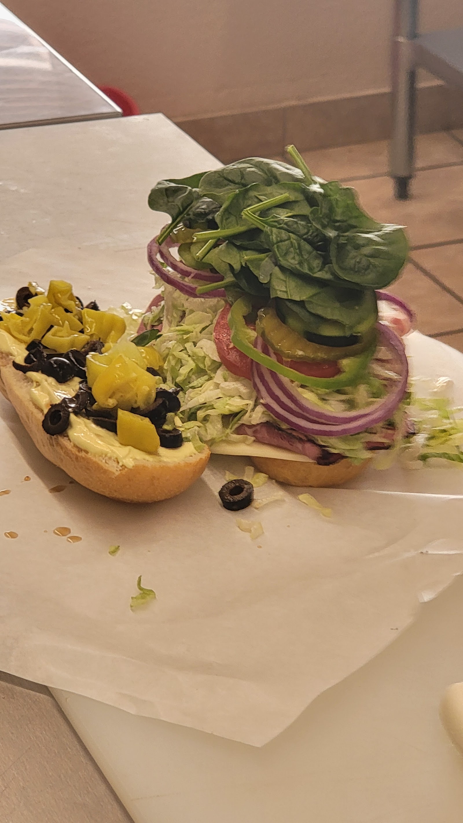 An open vegetable sandwich photographed at the shop